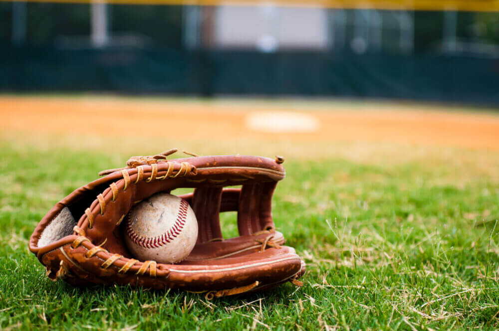 Old Baseball and Glove on Field